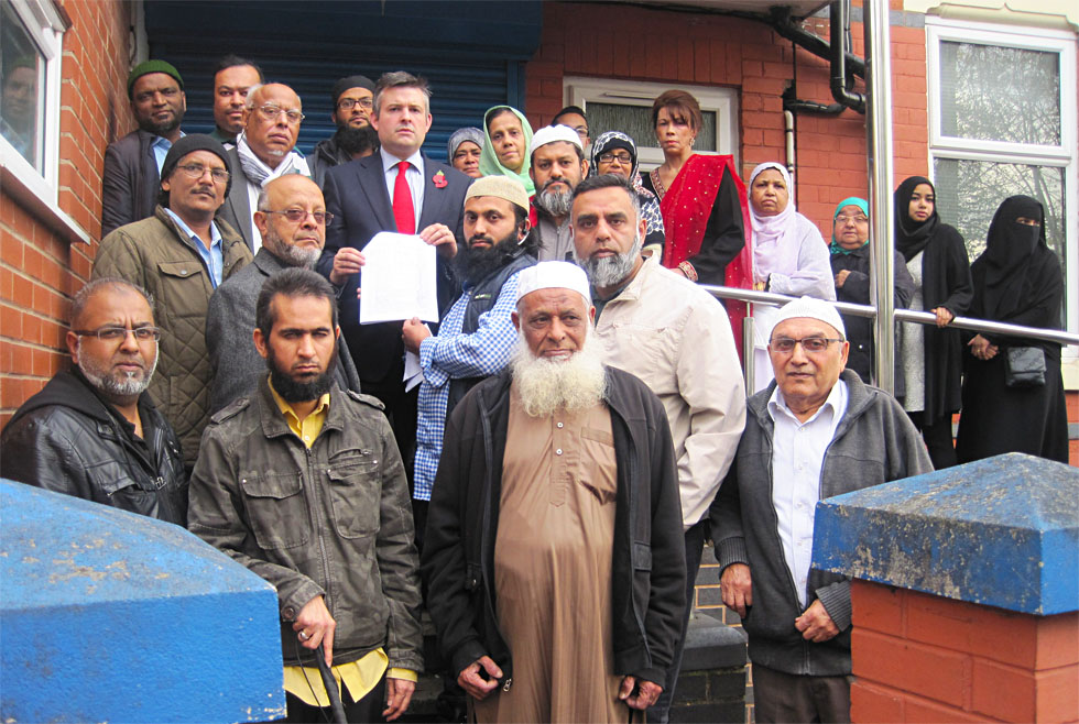 Jon with former patients and the petition on the steps of the Practice