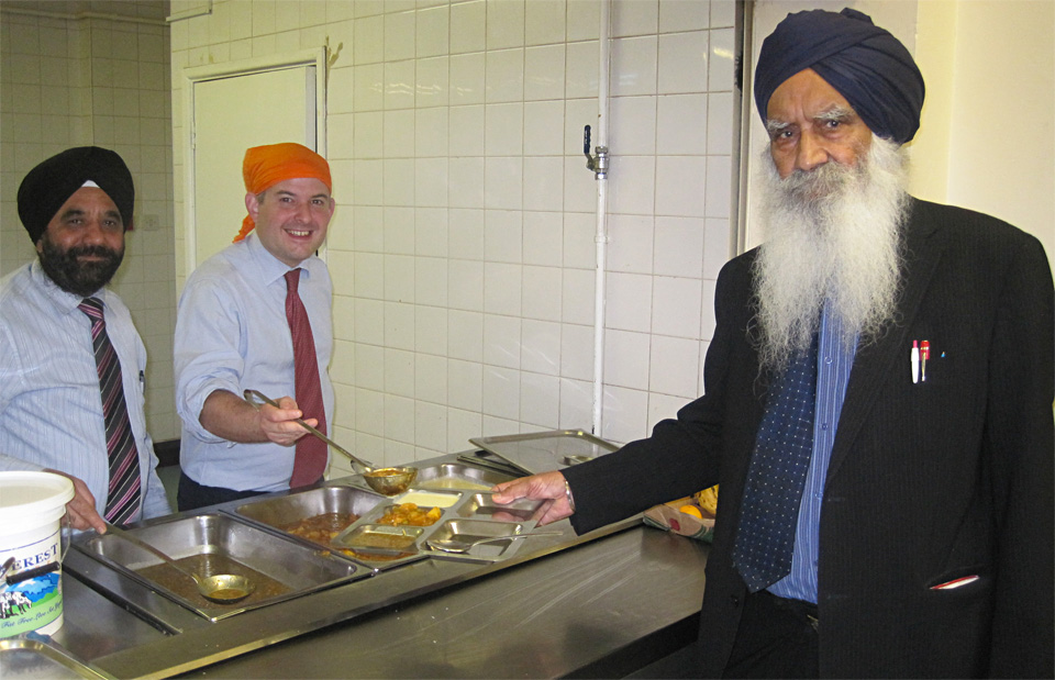 Jon serving food to the President of Guru Amar Das Gurdwara