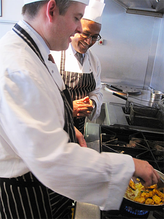 Jon preparing a curry dish under the guidance of Shaf Islam, chef and owner of Chutney Ivy